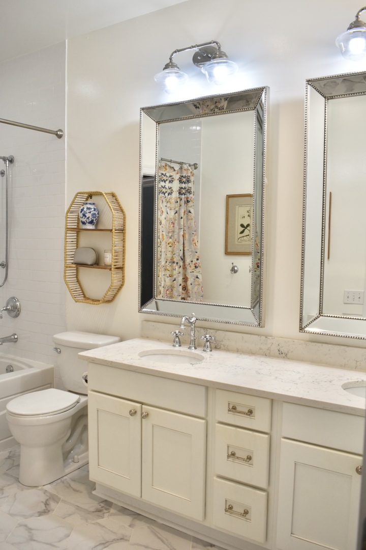 4315 North Kenmore Avenue, Unit 2S Chicago, IL 60613 - Photo 20 of 27 a bathroom with a granite countertop sink mirror and a toilet