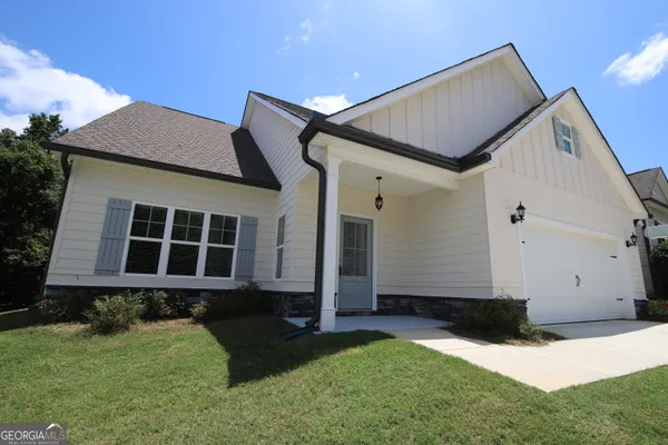 a front view of a house with garden