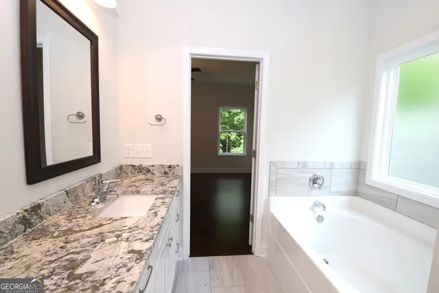 a bathroom with a bathtub and a sink