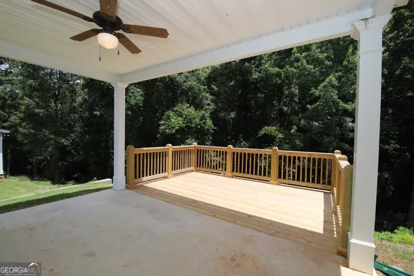 a view of balcony with a floor to ceiling window and wooden fence