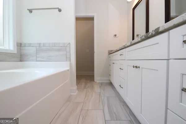 a bathroom with a bathtub and shower