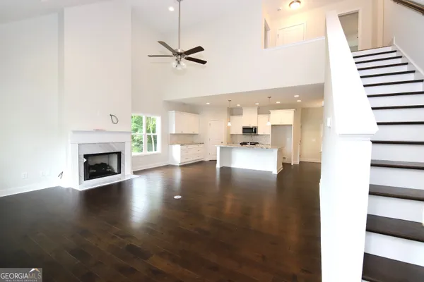 a view interior of a house with wooden floor a fireplace and windows
