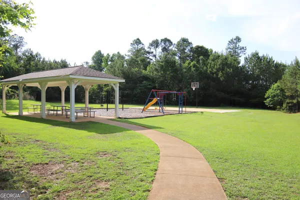 a view of a swimming pool with a garden and trees