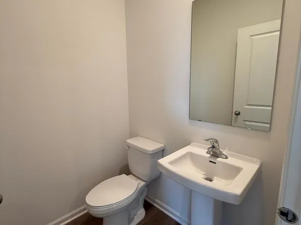 a bathroom with a sink a toilet and mirror