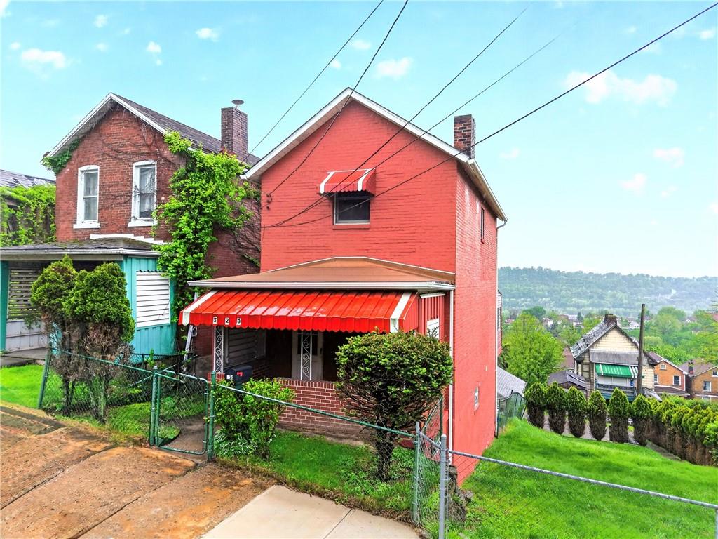 a view of front of house with a yard