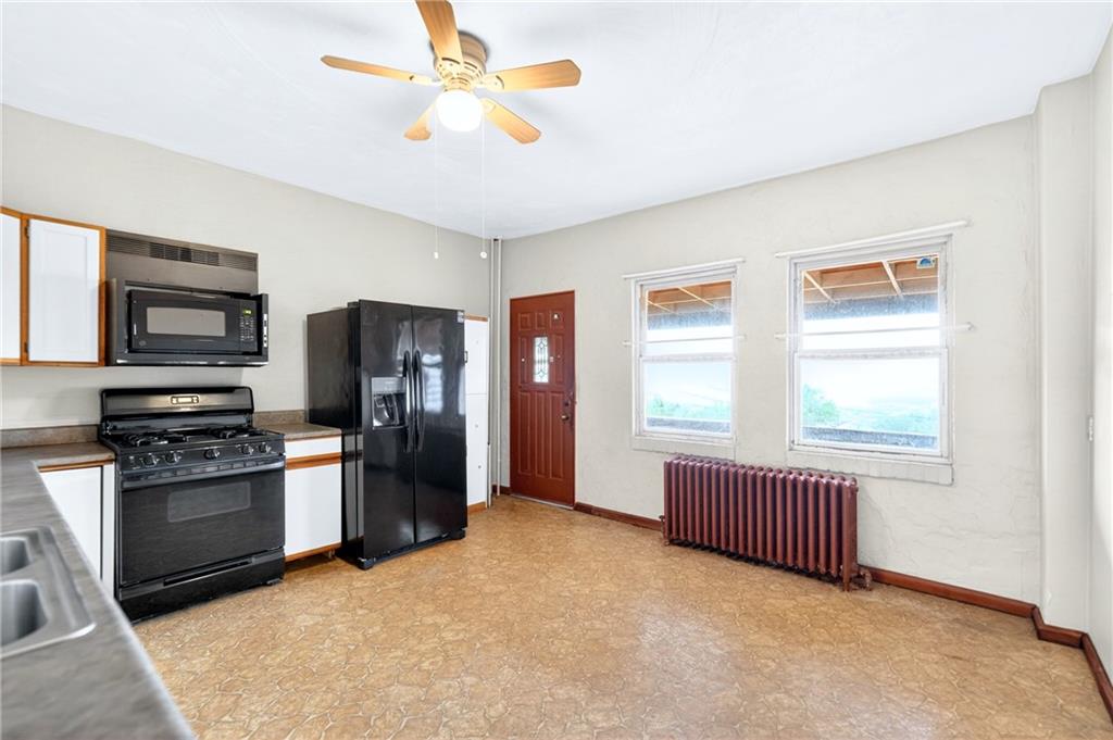 520 Stokes Avenue Braddock, PA 15104 - Photo 11 of 47 a view of an empty room with window and cabinet