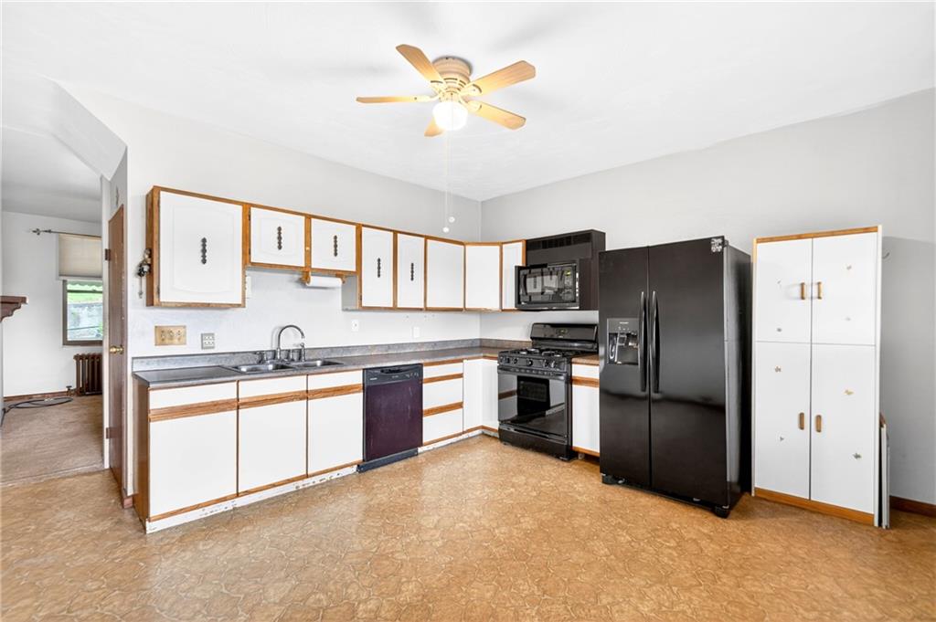 520 Stokes Avenue Braddock, PA 15104 - Photo 12 of 47 a kitchen with granite countertop a refrigerator oven a sink a stove and island