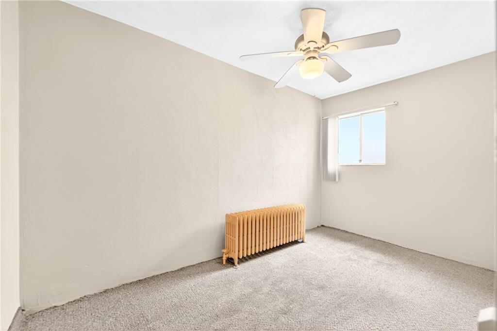 520 Stokes Avenue Braddock, PA 15104 - Photo 19 of 47 an empty room with windows and fan