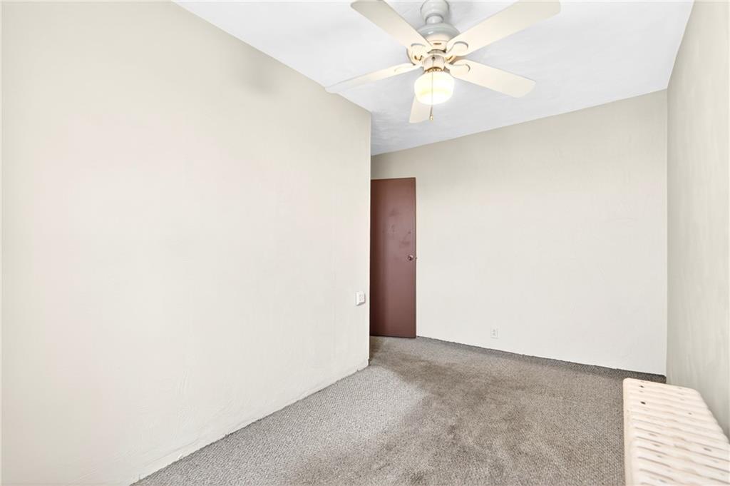 520 Stokes Avenue Braddock, PA 15104 - Photo 20 of 47 an empty room with a chandelier fan and windows