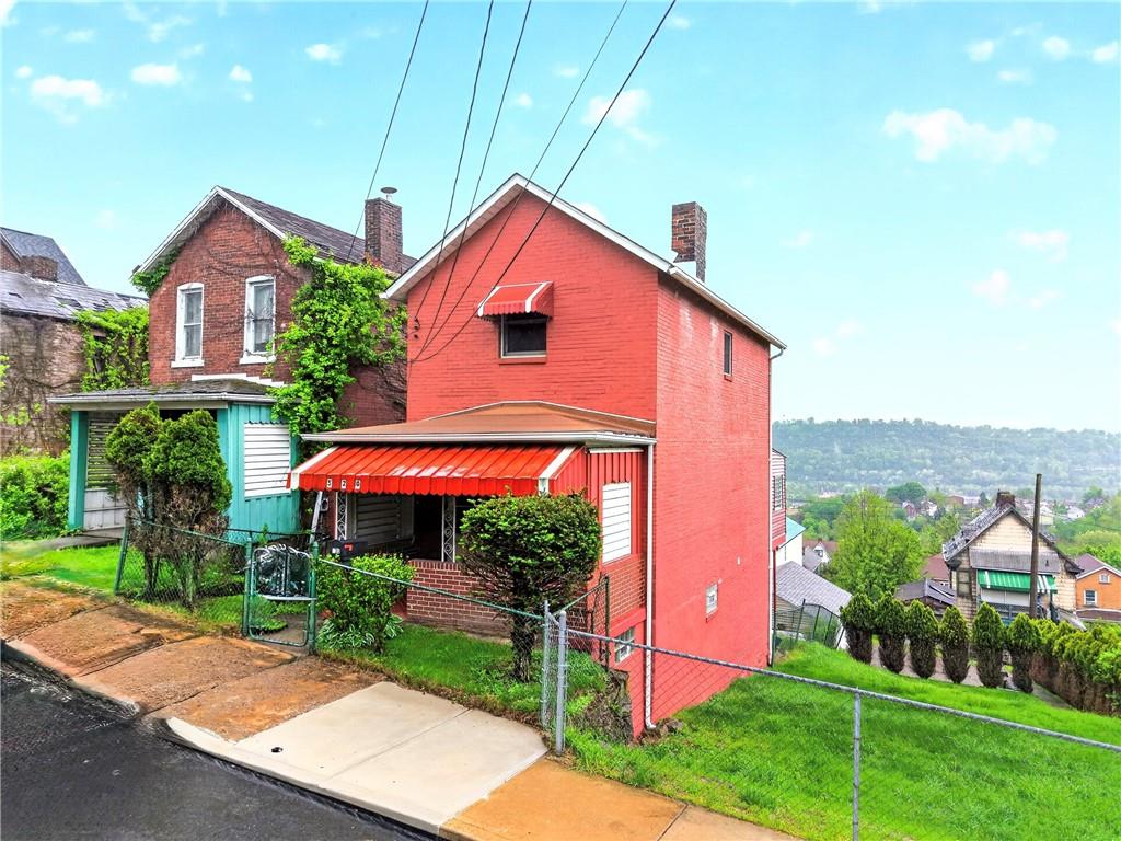520 Stokes Avenue Braddock, PA 15104 - Photo 2 of 47 a front view of a house with garden
