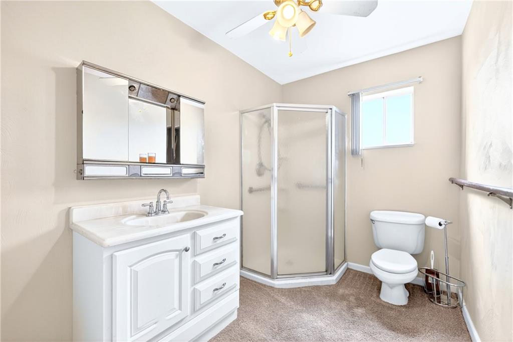 520 Stokes Avenue Braddock, PA 15104 - Photo 21 of 47 a spacious bathroom with a toilet sink and mirror