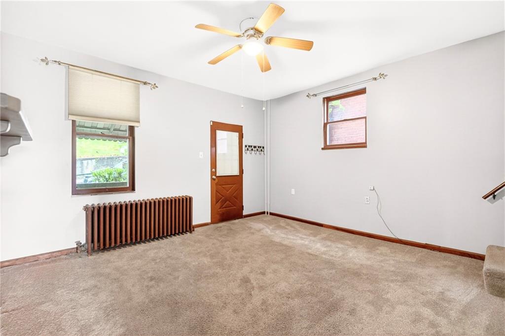520 Stokes Avenue Braddock, PA 15104 - Photo 9 of 47 an empty room with windows and a ceiling fan