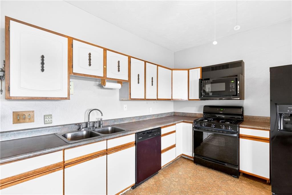 520 Stokes Avenue Braddock, PA 15104 - Photo 10 of 47 a kitchen with stainless steel appliances a stove sink microwave and cabinets