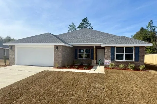 a front view of a house with a yard and seating space