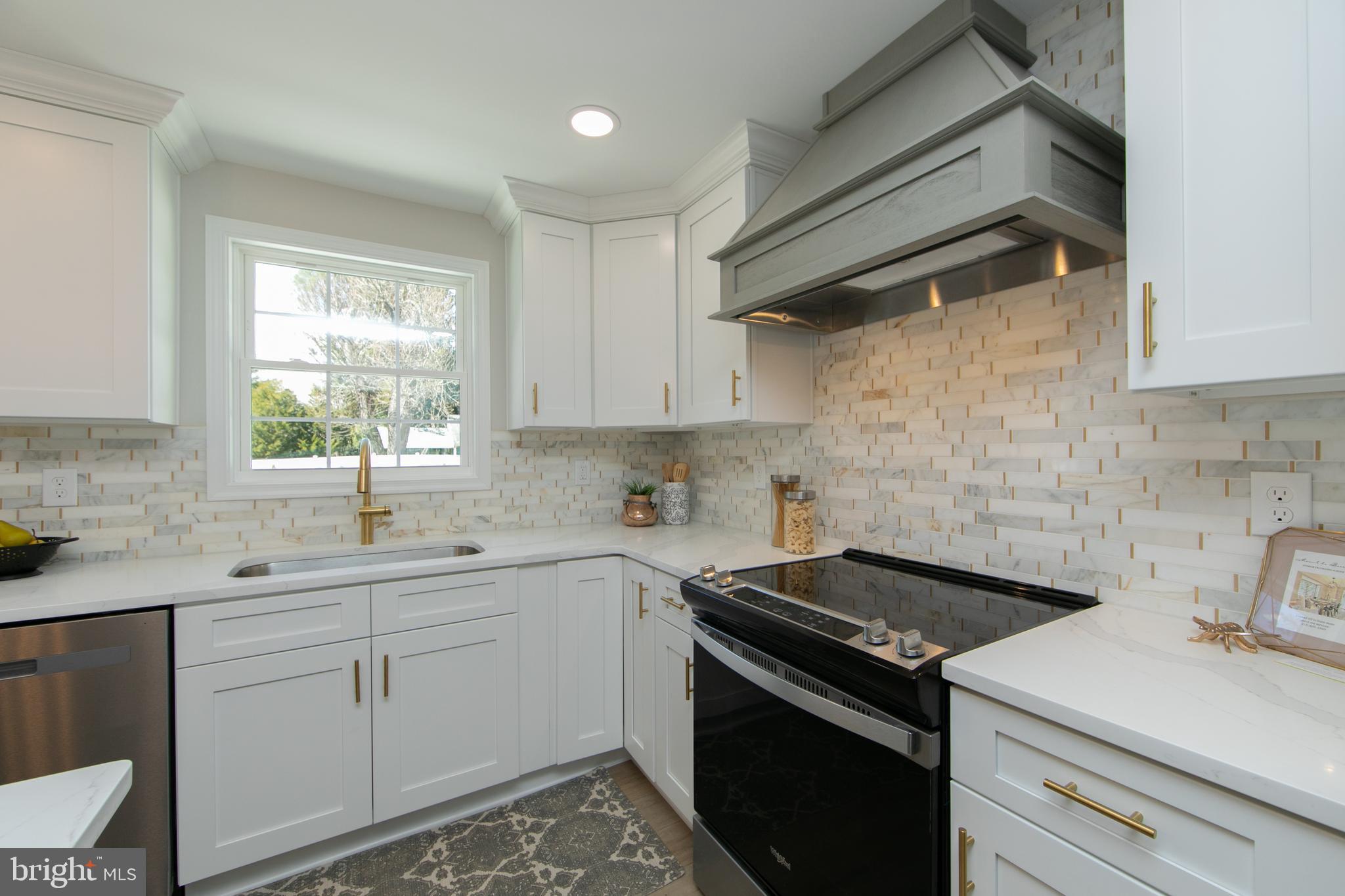 1324 Charleston Road Cherry Hill, NJ 08034 - Photo 12 of 34 a kitchen with a sink cabinets stainless steel appliances and a window
