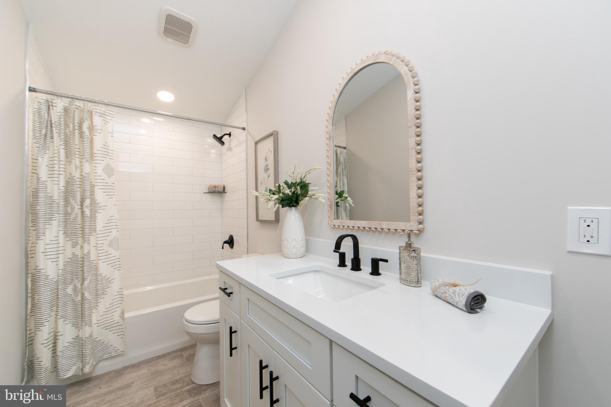 1324 Charleston Road Cherry Hill, NJ 08034 - Photo 30 of 34 a bathroom with a sink a toilet a shower and a mirror