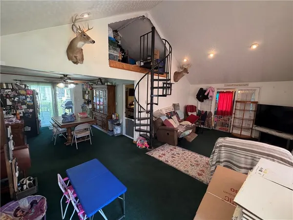 a living room with furniture a rug and white walls