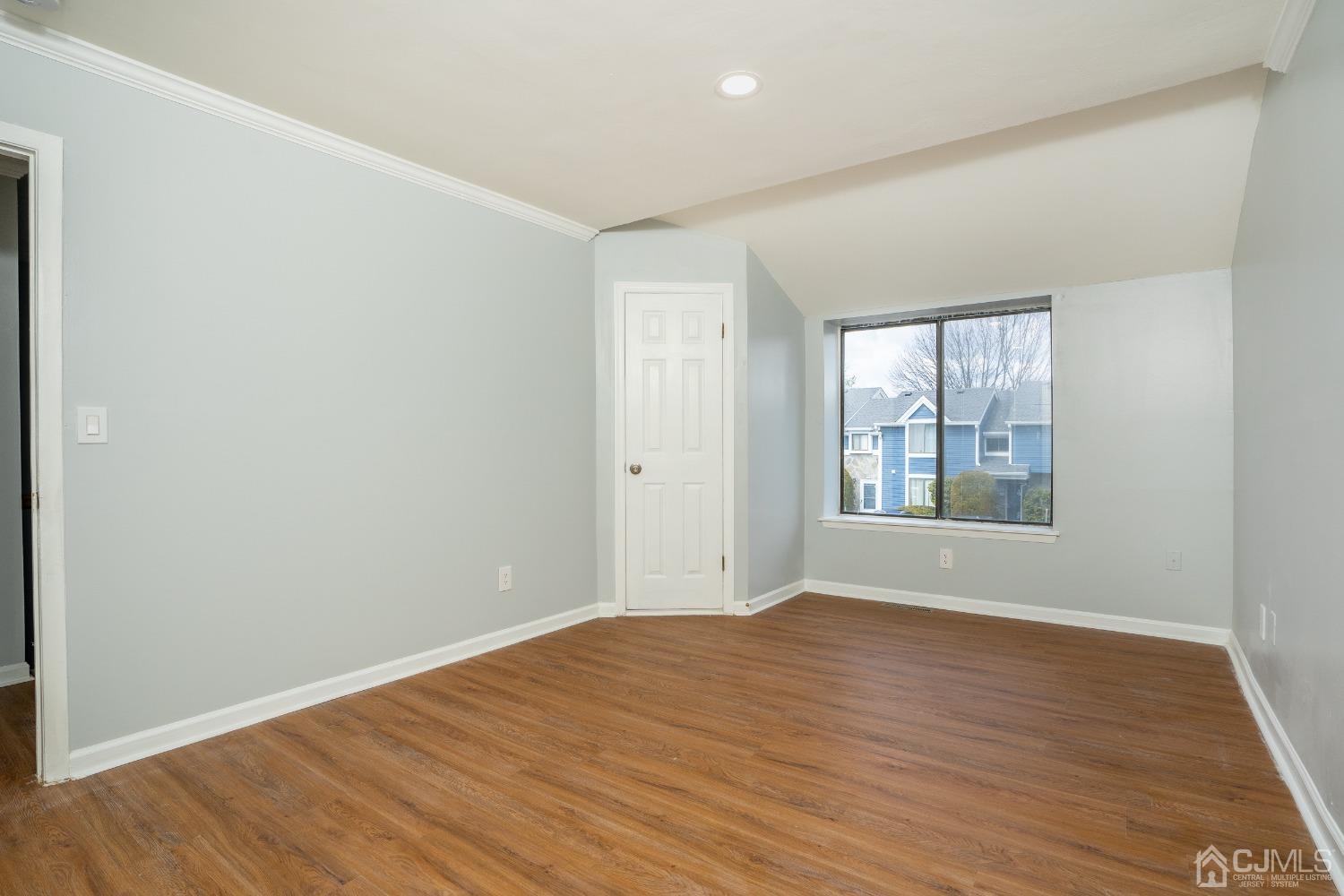 5505 Hana Road Edison, NJ 08817 - Photo 20 of 32 an empty room with wooden floor and windows