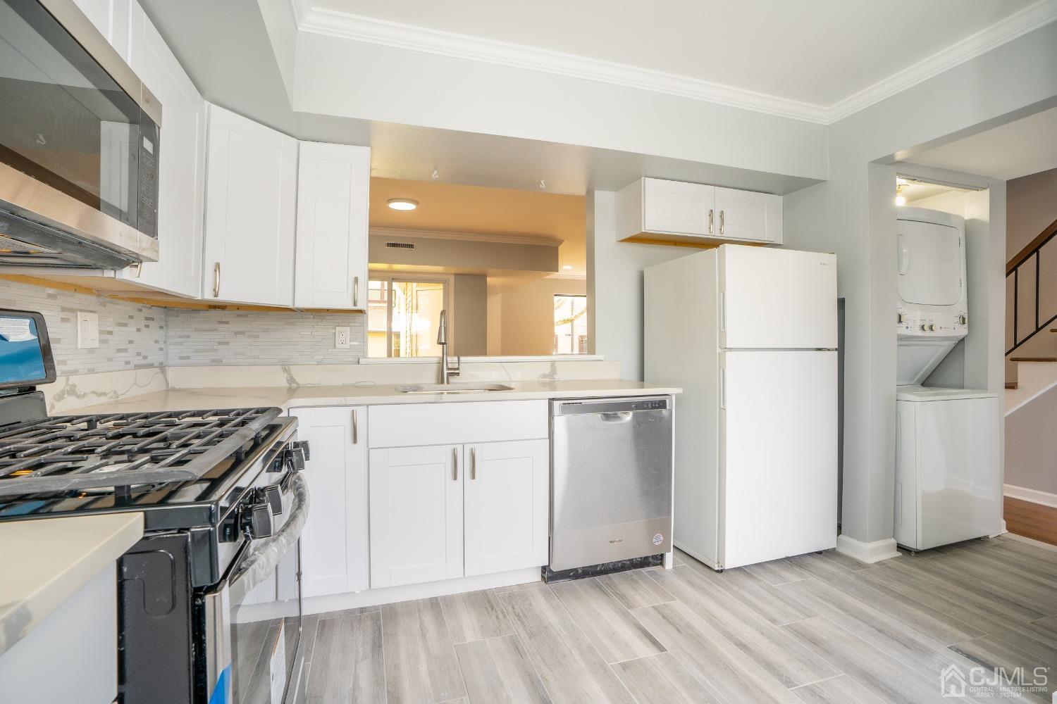 5505 Hana Road Edison, NJ 08817 - Photo 3 of 32 a kitchen with a refrigerator a stove top oven a sink and cabinets