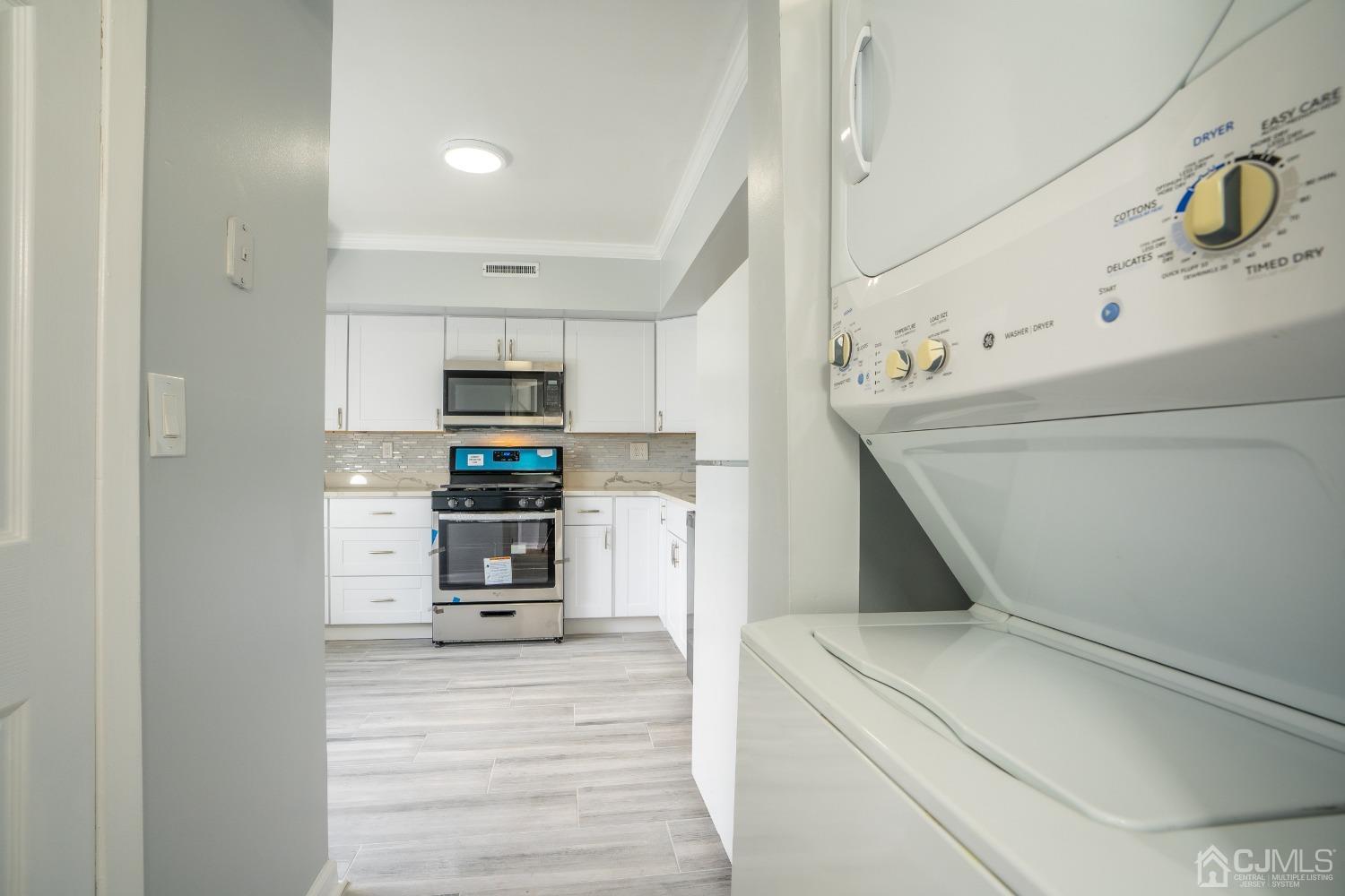 5505 Hana Road Edison, NJ 08817 - Photo 5 of 32 a kitchen with a refrigerator and a stove top oven