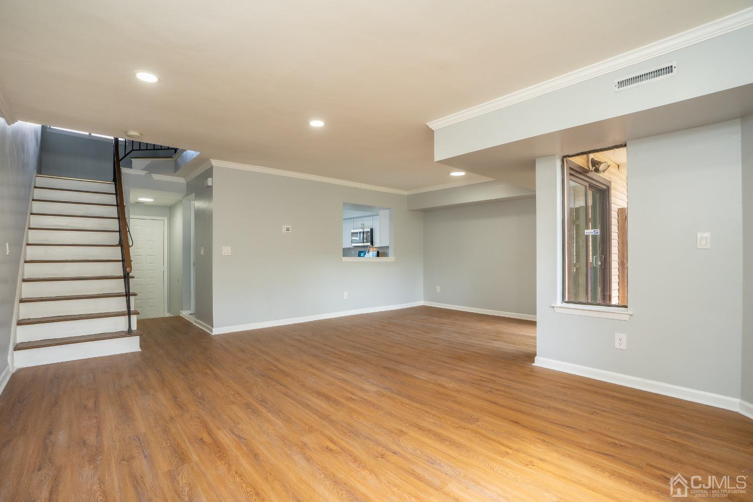5505 Hana Road Edison, NJ 08817 - Photo 9 of 32 a view of an empty room with wooden floor and a window