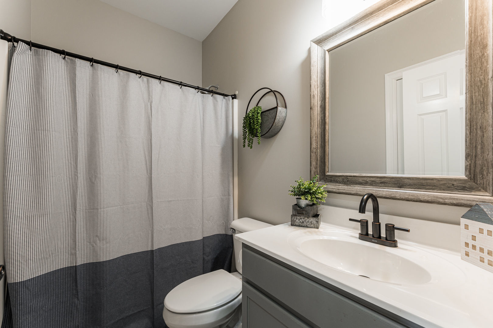 461 White Street Sycamore, IL 60178 - Photo 21 of 49 a bathroom with a sink a toilet and shower curtain