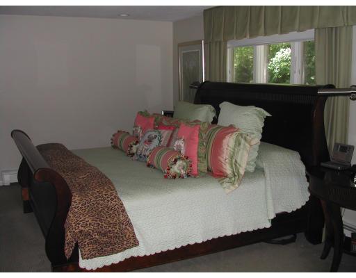224 Country Way Needham, MA 02492 - Photo 13 of 20 a bed sitting in a bedroom next to a window
