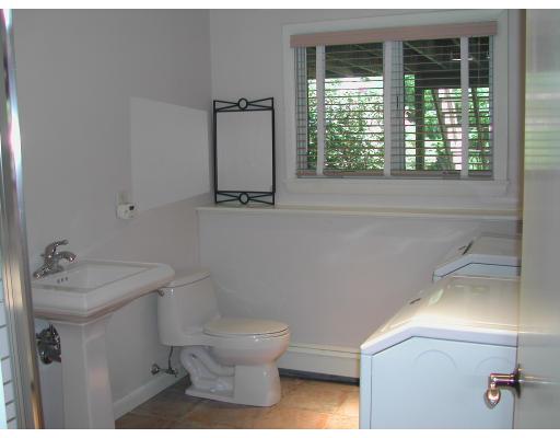 224 Country Way Needham, MA 02492 - Photo 20 of 20 a white toilet sitting next to a bathroom sink