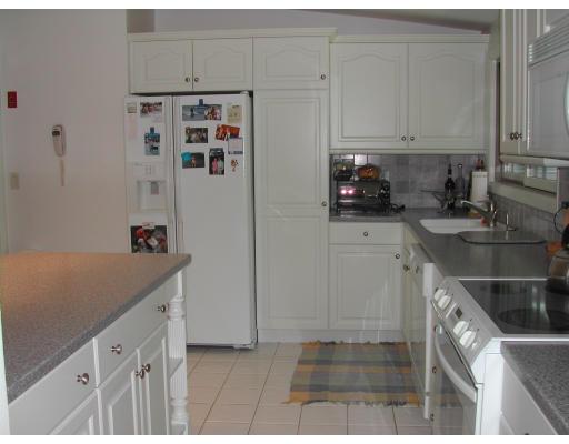 224 Country Way Needham, MA 02492 - Photo 5 of 20 a kitchen with stainless steel appliances cabinets and a refrigerator