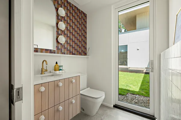 a bathroom with a toilet a sink and a window