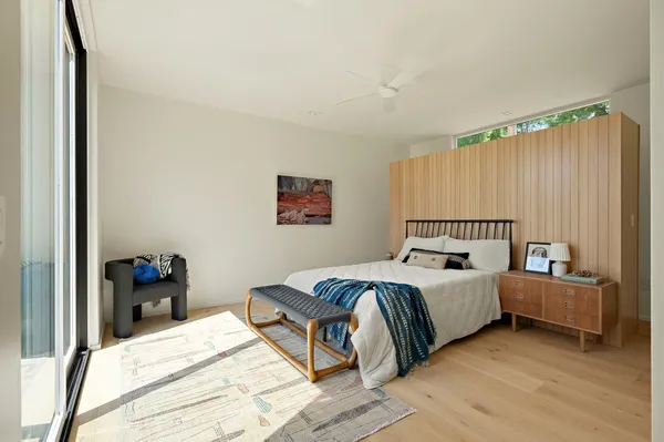 a bed room with a bed and a chair