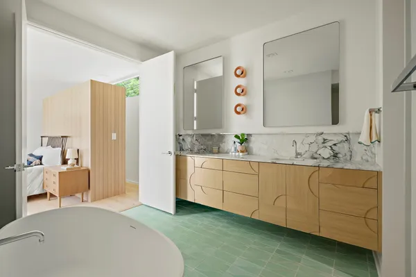 a spacious bathroom with a double vanity sink and mirror