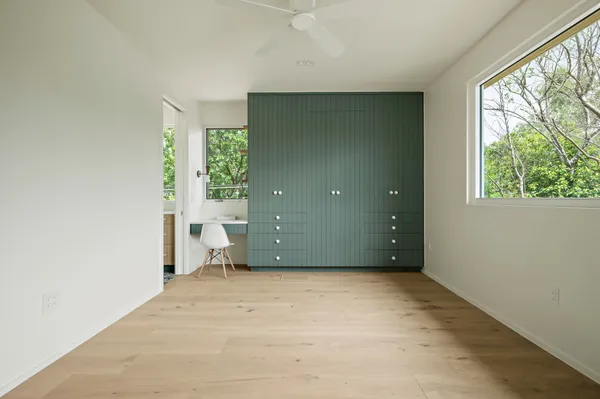 an empty room with large windows