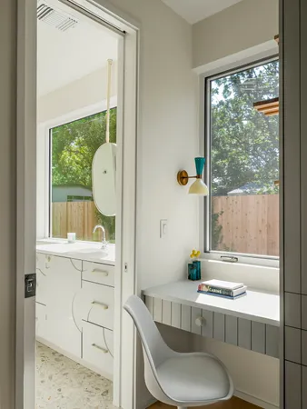 a bathroom with a toilet a sink and a window