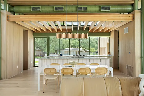 a dining table with chairs and window