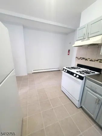 a view of kitchen with white cabinets and appliances