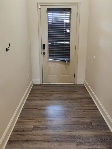 a view of wooden floor and windows in a room