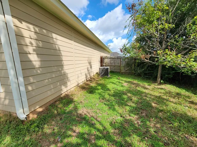 a backyard of a house with table and chairs