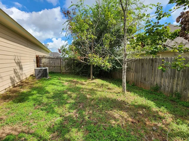 a backyard of a house with lots of green space
