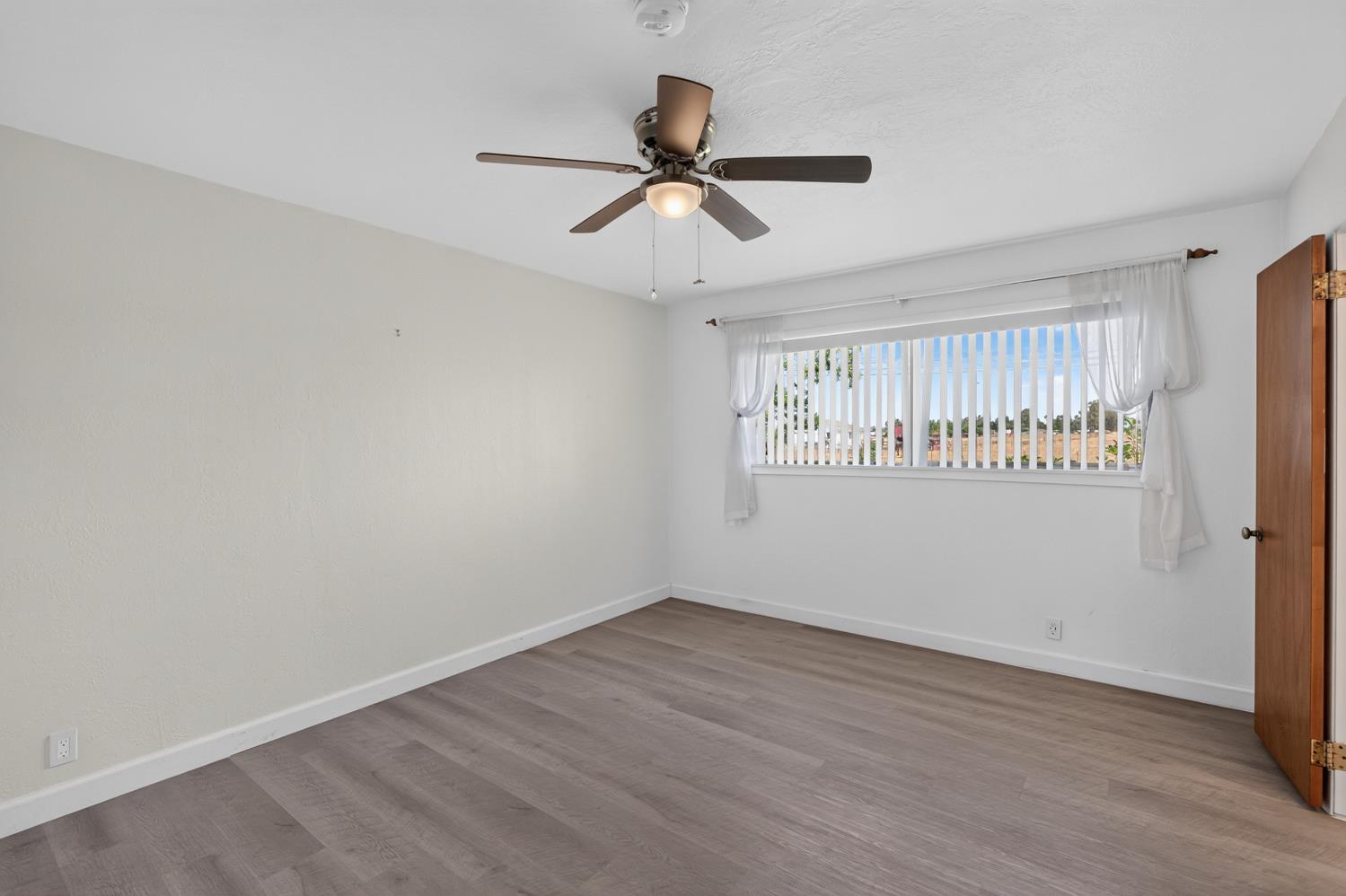 10700 Calvine Road Elk Grove, CA 95830 - Photo 28 of 73 a view of an empty room with a window