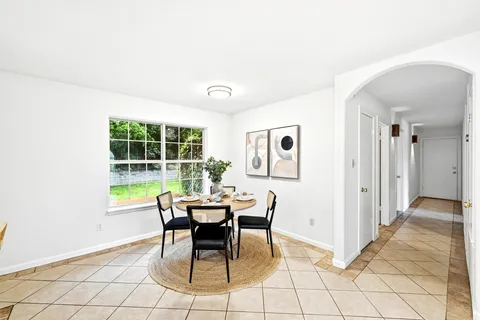 a dining room with furniture and window