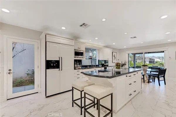 a view of kitchen with dining table and chairs