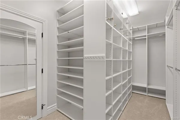 a view of walk in closet with empty racks