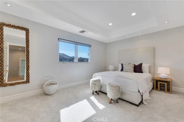 a spacious bedroom with a bed and window