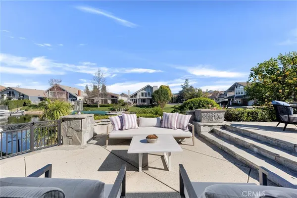 a view of a terrace with couches and sky view