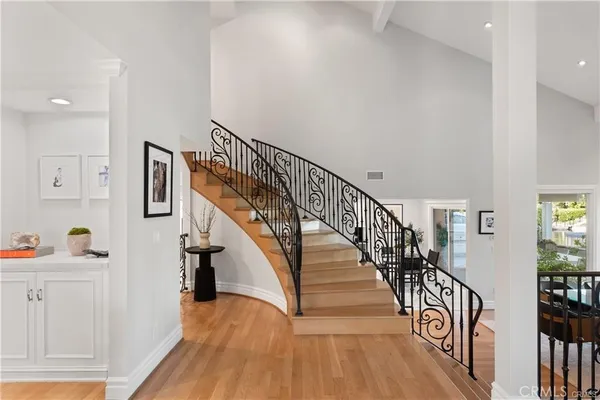 a view of entryway and hall with wooden floor