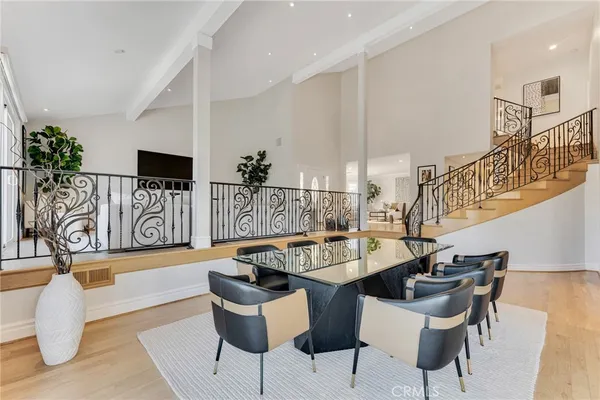 a dining room with furniture and wooden floor