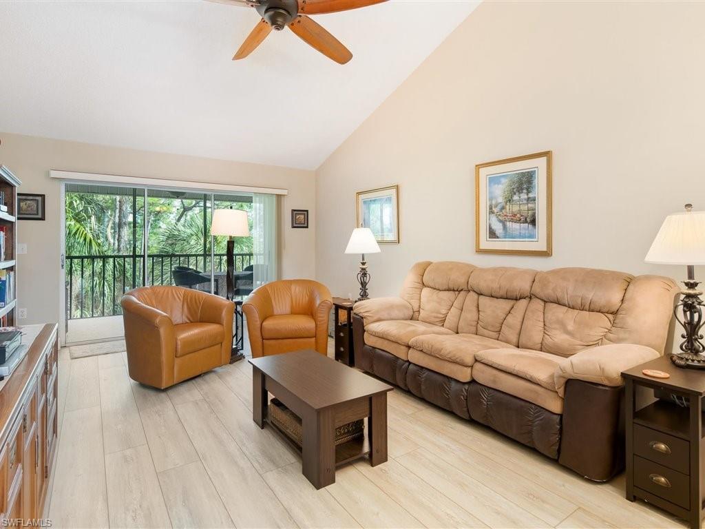 3012 Sandpiper Bay Circle, Unit D301 Naples, FL 34112 - Photo 1 of 23 a living room with furniture and a large window
