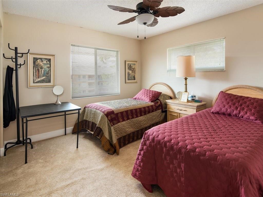 3012 Sandpiper Bay Circle, Unit D301 Naples, FL 34112 - Photo 14 of 23 a bedroom with two beds and window