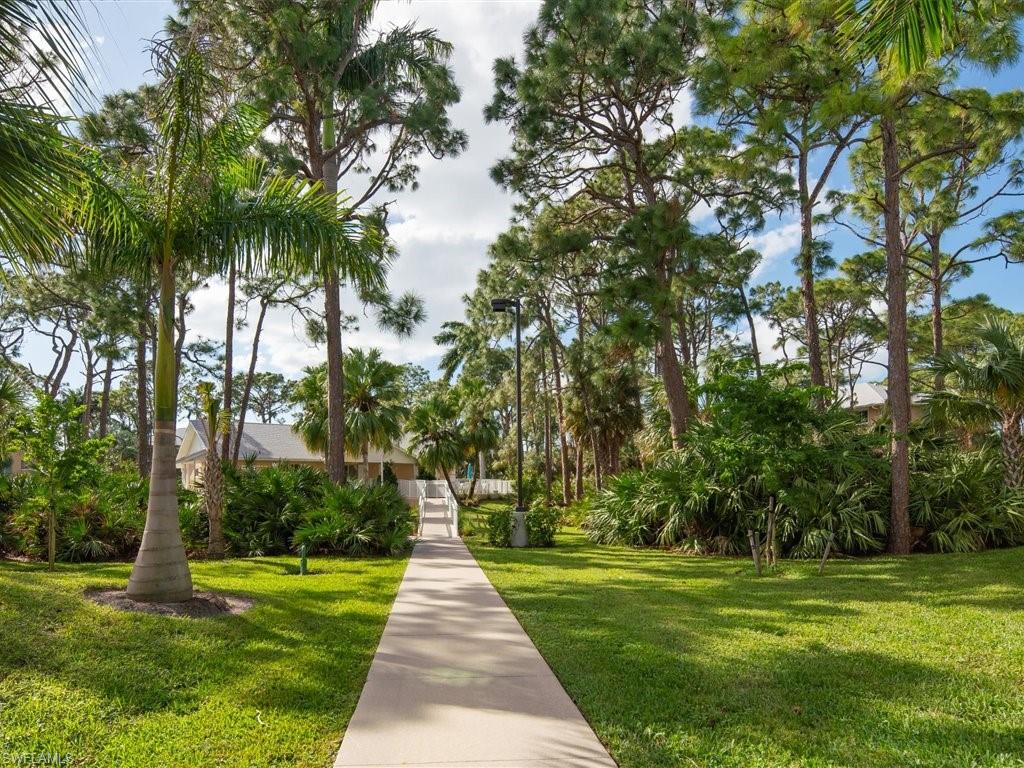 3012 Sandpiper Bay Circle, Unit D301 Naples, FL 34112 - Photo 15 of 23 a front view of a house with a yard